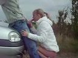 GUY GETS ROAD HEAD FROM HOT BLOND OUTSIDE OF CAR. THEY ARE FULLY CLOTHED AND IT IS COLD OUTSIDE. HE CUMS ALL OVER HER FACE