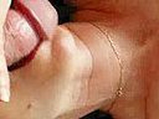 Cute black haired mature woman with lovely facial moles and wearing nothing but golden chain necklace blows very thick amateur cock with tender dedication, laying on her back in her bedroom.