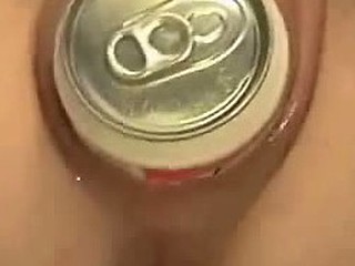 Unruly wanton dame pushes beer can inside her wide vagina. It makes her feel some kind of pleasurable pain and she moans aloud as it disappears inside her pussy.